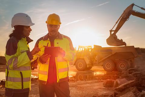 Two people discussing a construction project on site